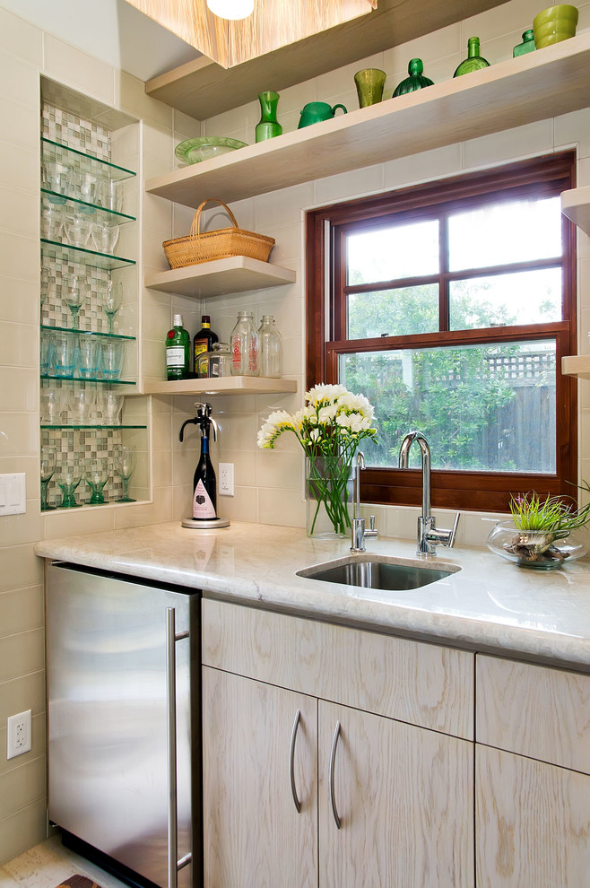 Mid-sized transitional single-wall wet bar photo in San Francisco with an undermount sink, flat-panel cabinets, light wood cabinets, beige backsplash, quartzite countertops, subway tile backsplash and white countertops