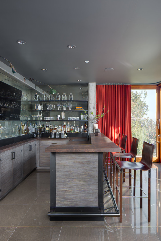 This is an example of a large contemporary l-shaped breakfast bar in San Francisco with mirror splashback, grey floors, a submerged sink, flat-panel cabinets and grey cabinets.