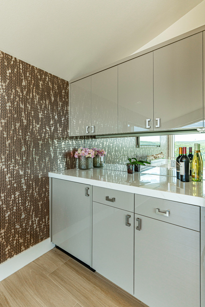 Small retro single-wall home bar in Austin with no sink, flat-panel cabinets, grey cabinets, engineered stone countertops, mirror splashback, beige floors, white worktops and a feature wall.