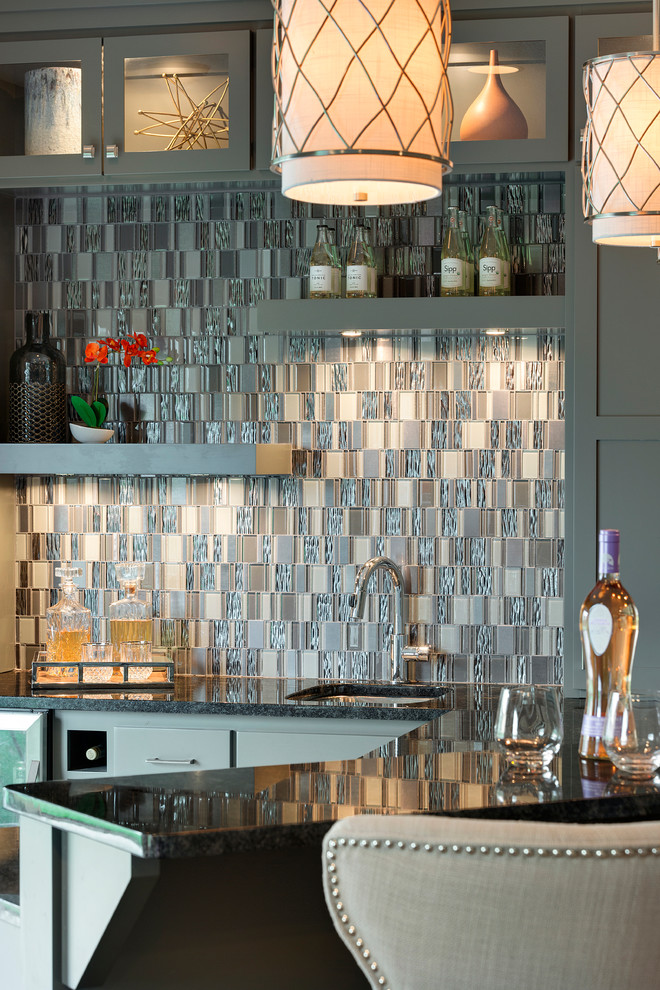 Photo of a medium sized classic l-shaped breakfast bar in Minneapolis with shaker cabinets, grey cabinets, granite worktops, multi-coloured splashback, mosaic tiled splashback, porcelain flooring and a submerged sink.