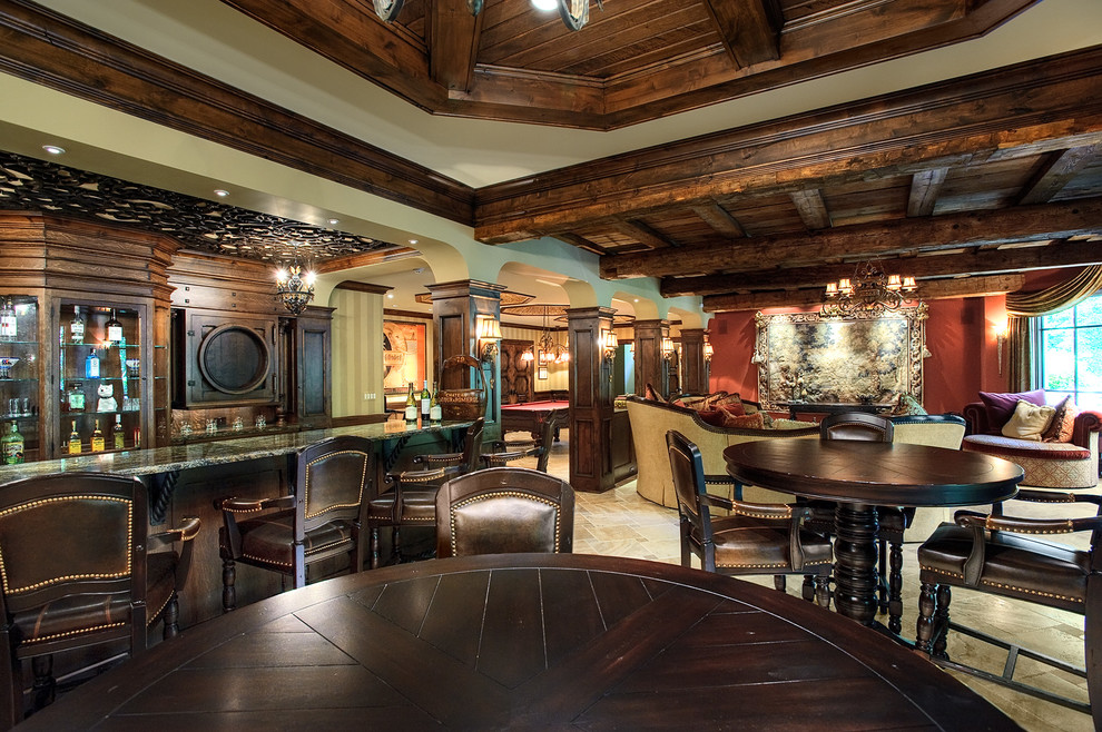 Cette image montre un grand bar de salon avec évier parallèle traditionnel en bois foncé avec un plan de travail en granite et un sol en carrelage de céramique.