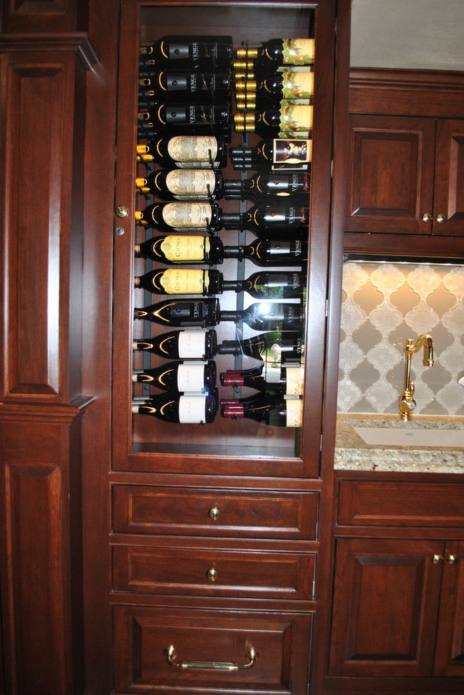Large traditional single-wall wet bar in St Louis with beaded cabinets, dark wood cabinets and granite worktops.