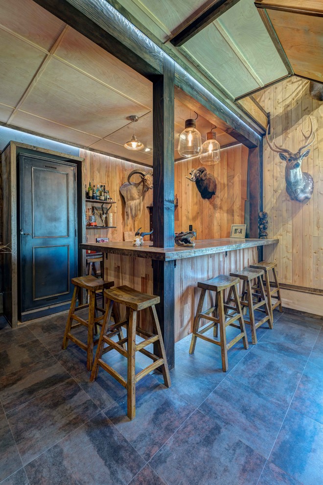 Photo of a large rustic u-shaped wet bar in Seattle with a built-in sink, recessed-panel cabinets, dark wood cabinets, brown splashback, wood splashback, ceramic flooring and grey floors.