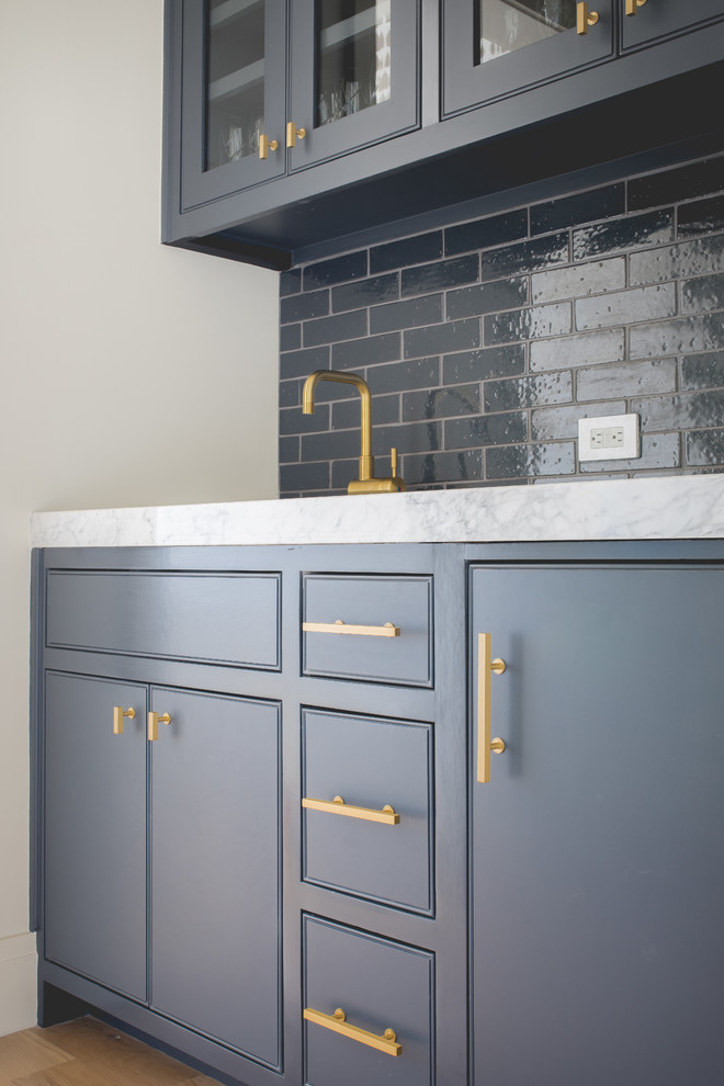 Inspiration for a small contemporary single-wall wet bar in Dallas with grey cabinets, marble worktops, blue splashback, metro tiled splashback, medium hardwood flooring and beaded cabinets.