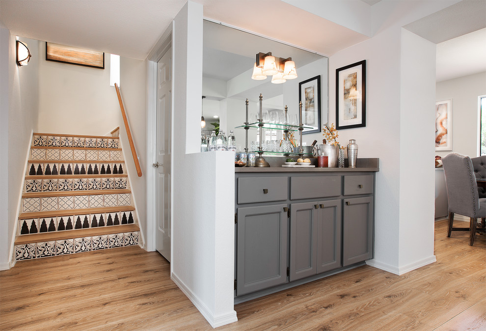 Small trendy home bar photo in Phoenix with gray cabinets, quartz countertops, gray backsplash, stone slab backsplash and recessed-panel cabinets