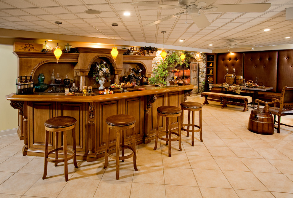 Mediterranean breakfast bar in Philadelphia with raised-panel cabinets, medium wood cabinets, granite worktops, porcelain flooring and beige floors.