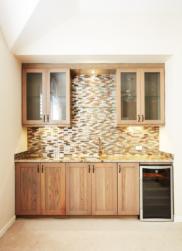 Small tuscan single-wall carpeted and beige floor wet bar photo in Dallas with an undermount sink, shaker cabinets, medium tone wood cabinets, granite countertops, multicolored backsplash and matchstick tile backsplash