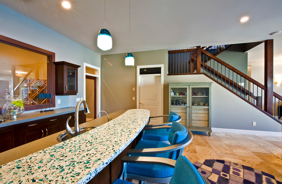 Seated home bar - mid-sized galley ceramic tile seated home bar idea in Vancouver with a drop-in sink, recessed-panel cabinets, dark wood cabinets and recycled glass countertops