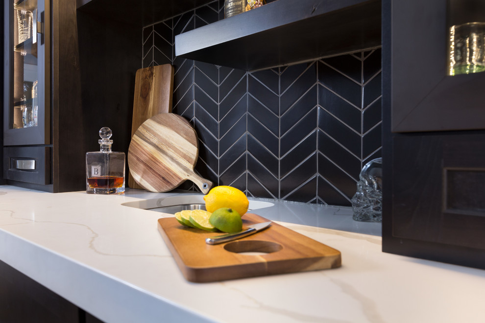 Wet bar - small contemporary galley porcelain tile and brown floor wet bar idea in Other with an undermount sink, recessed-panel cabinets, black cabinets, quartz countertops, black backsplash, ceramic backsplash and white countertops