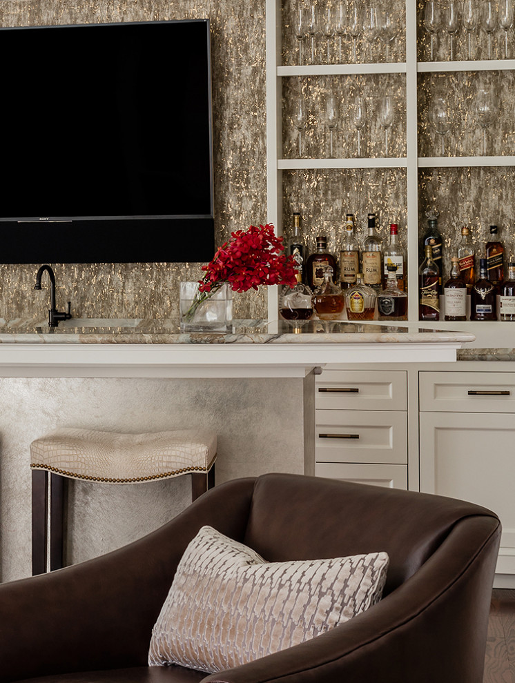 Inspiration for a large traditional single-wall wet bar in Boston with a submerged sink, recessed-panel cabinets, white cabinets, marble worktops, beige splashback, marble splashback, dark hardwood flooring, brown floors and beige worktops.