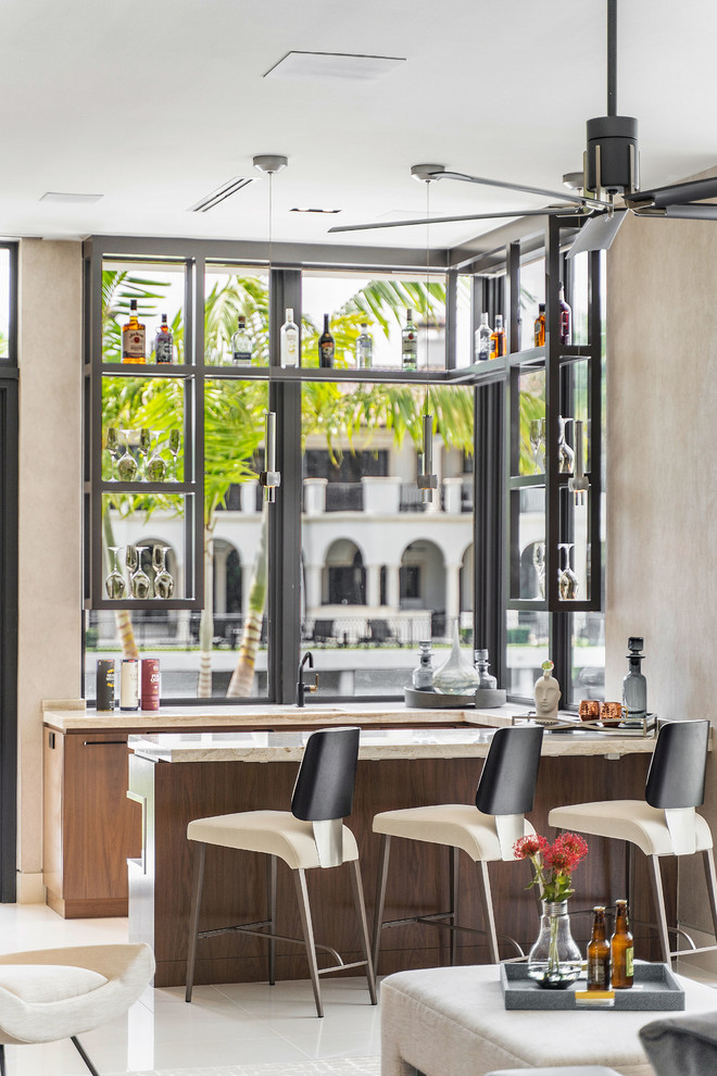 Inspiration for a contemporary u-shaped white floor home bar remodel in Miami with flat-panel cabinets, medium tone wood cabinets and beige countertops