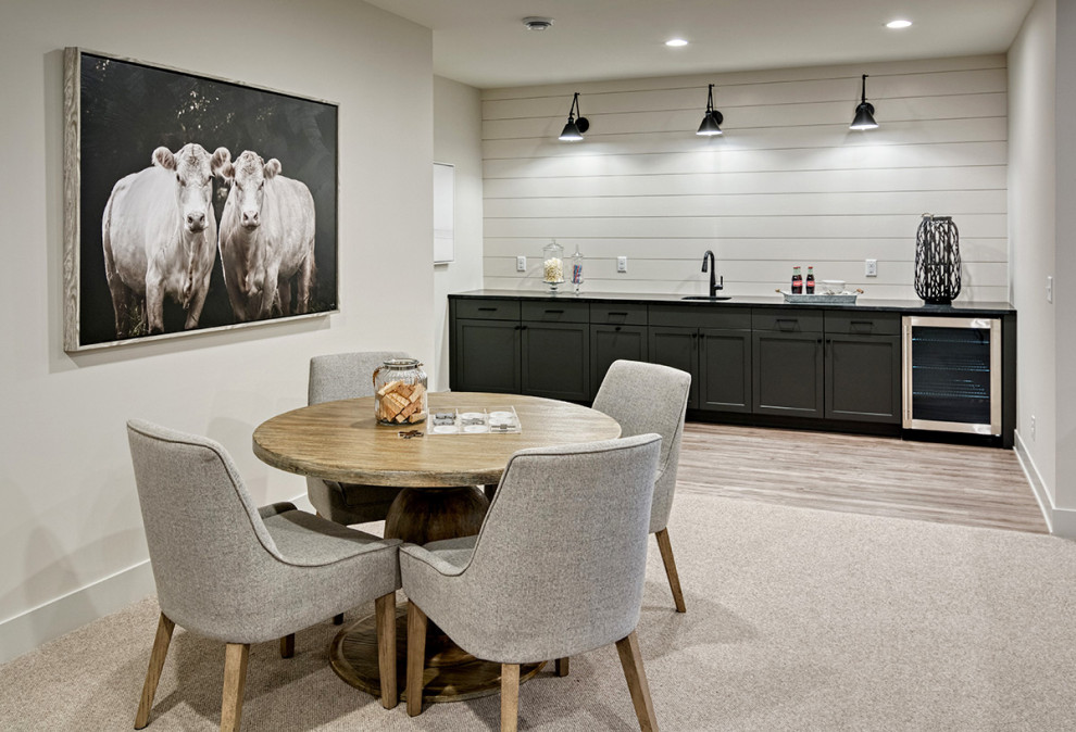 Large country l-shaped linoleum floor and brown floor wet bar photo in Minneapolis with an undermount sink, flat-panel cabinets, black cabinets, quartz countertops and black countertops