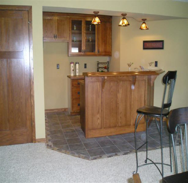 Example of a small classic ceramic tile and gray floor seated home bar design in Minneapolis with glass-front cabinets, medium tone wood cabinets and wood countertops
