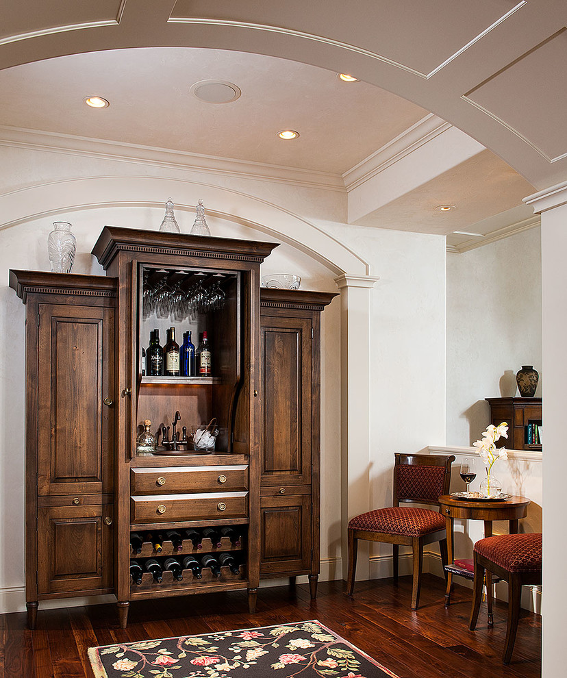 Modelo de bar en casa con fregadero lineal clásico de tamaño medio con armarios con paneles con relieve, puertas de armario de madera en tonos medios y suelo de madera oscura