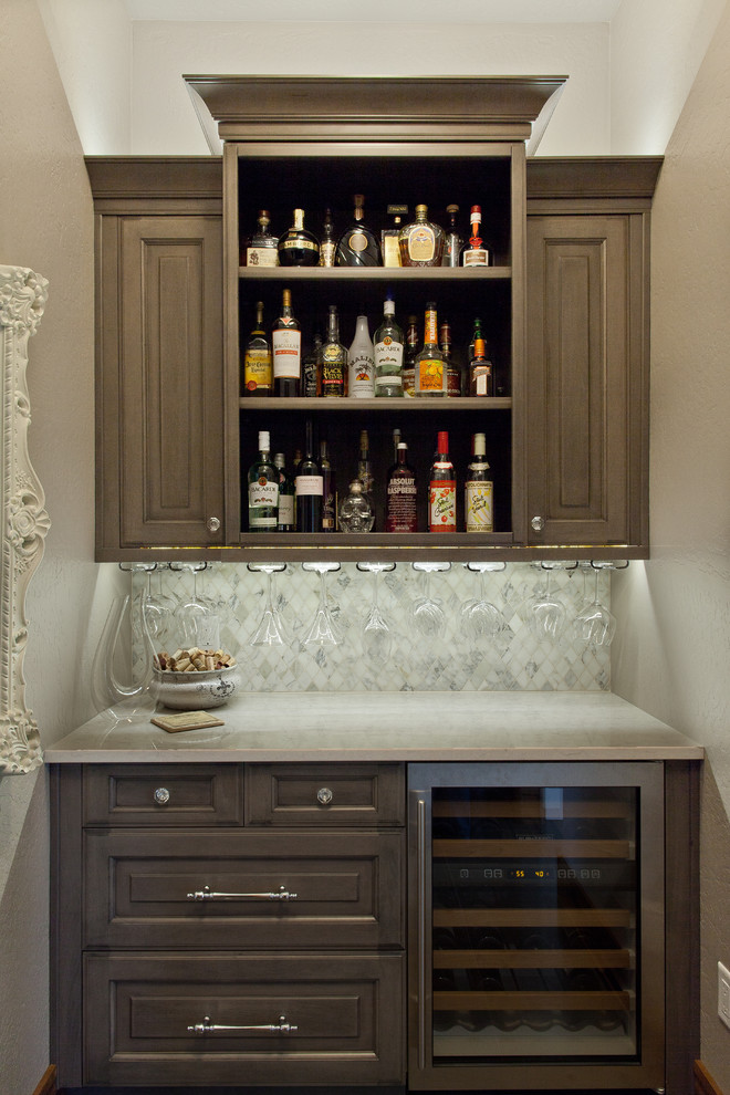 Home bar - small traditional home bar idea in Other with marble backsplash