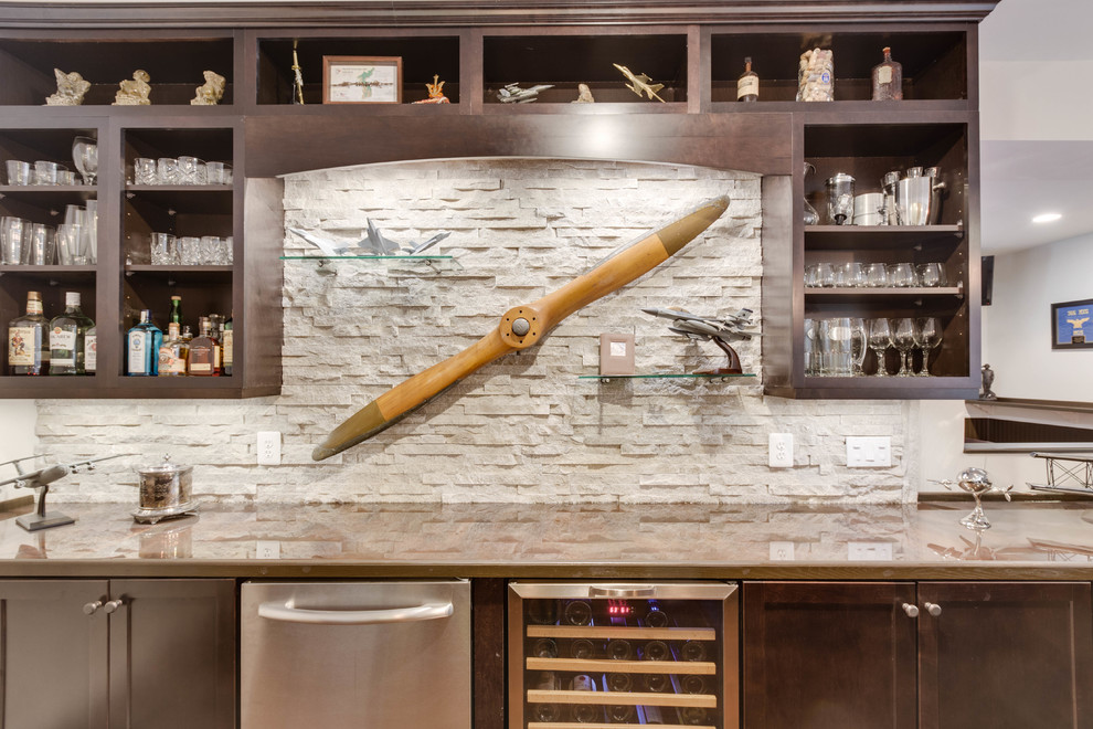 Example of a large minimalist u-shaped medium tone wood floor wet bar design in DC Metro with a drop-in sink, recessed-panel cabinets, copper countertops and stone tile backsplash