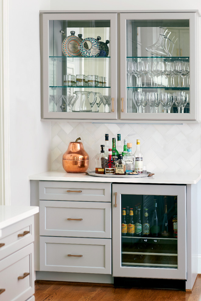 Einzeilige Klassische Hausbar mit Schrankfronten mit vertiefter Füllung, grauen Schränken, Küchenrückwand in Weiß und braunem Holzboden in Raleigh