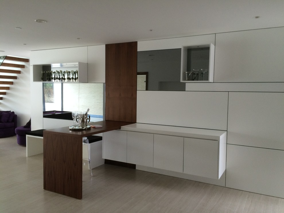 Design ideas for a medium sized contemporary single-wall wet bar in Dorset with flat-panel cabinets, white cabinets, wood worktops, white splashback, glass sheet splashback, ceramic flooring and brown worktops.