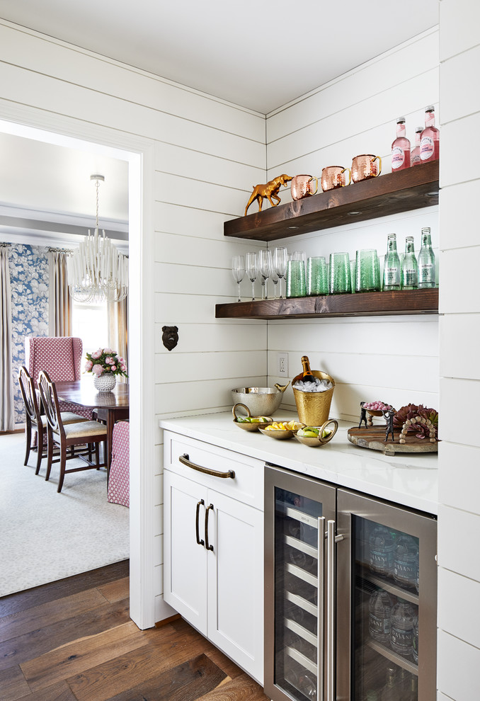 Inspiration for a small farmhouse single-wall home bar in DC Metro with no sink, shaker cabinets, white cabinets, dark hardwood flooring, brown floors and white worktops.