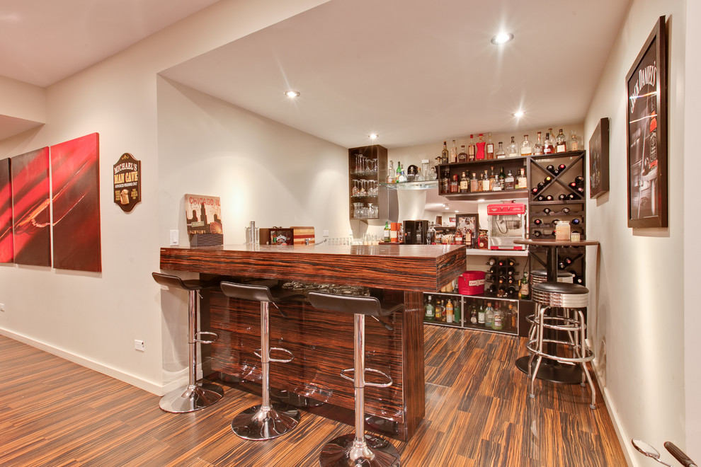 Inspiration for a modern laminate floor home bar remodel in Chicago
