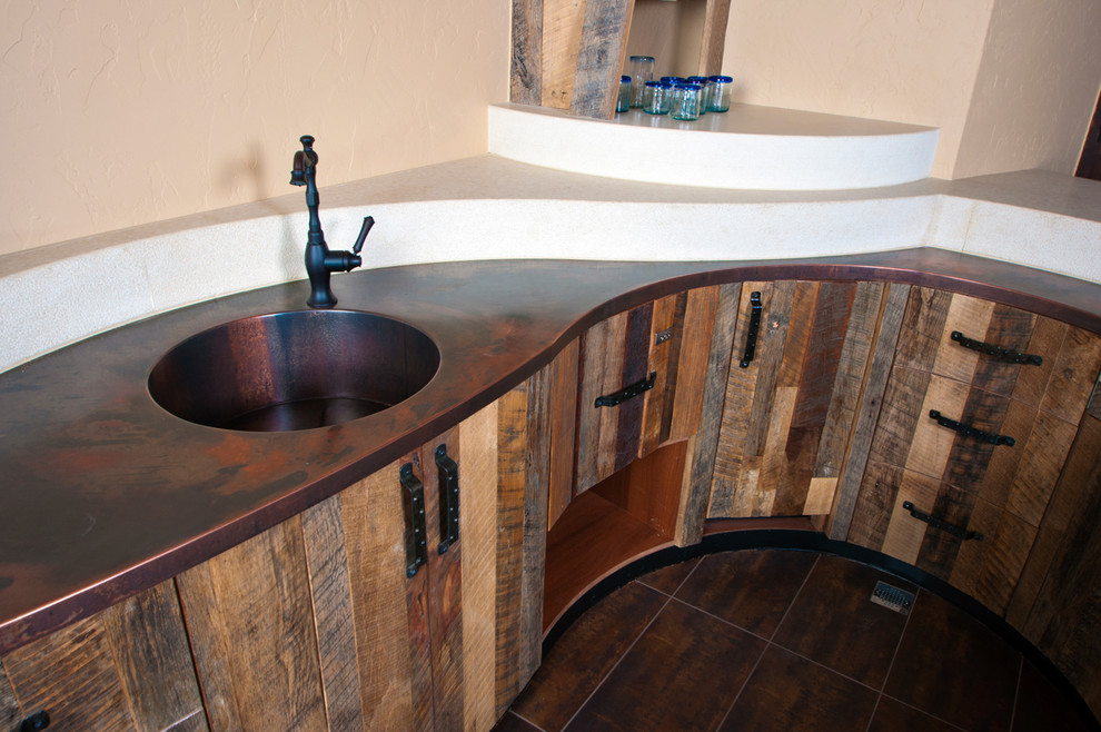 Inspiration for a transitional u-shaped porcelain tile seated home bar remodel in Denver with an integrated sink, flat-panel cabinets, distressed cabinets and copper countertops