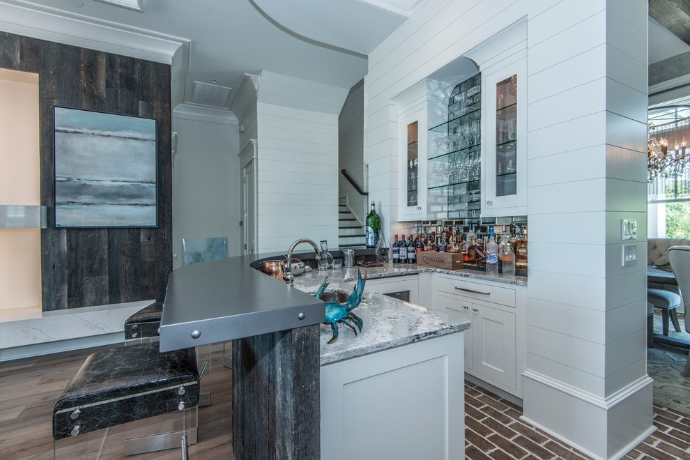 Seated home bar - mid-sized eclectic l-shaped medium tone wood floor and gray floor seated home bar idea in Charleston with an undermount sink, gray cabinets, zinc countertops, multicolored backsplash and mirror backsplash