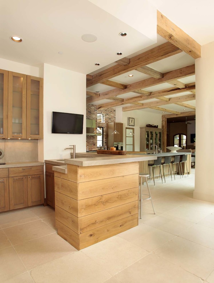 Example of a large transitional l-shaped travertine floor wet bar design in Houston with an undermount sink, shaker cabinets, light wood cabinets, concrete countertops, gray backsplash and stone slab backsplash
