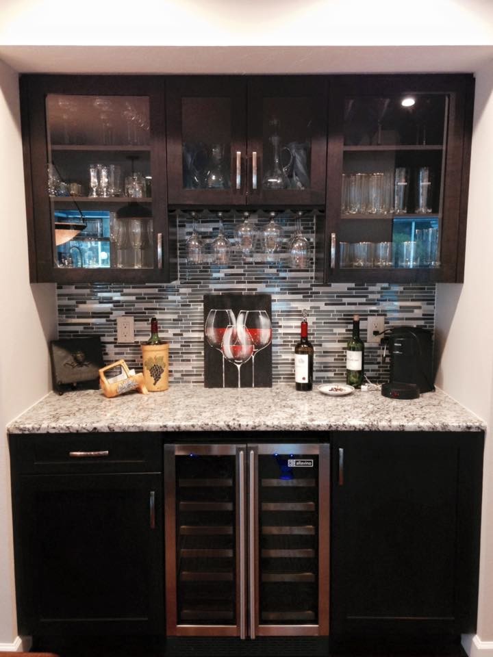Inspiration for a mid-sized contemporary single-wall wet bar remodel in Tampa with no sink, shaker cabinets, dark wood cabinets, granite countertops, gray backsplash and glass tile backsplash