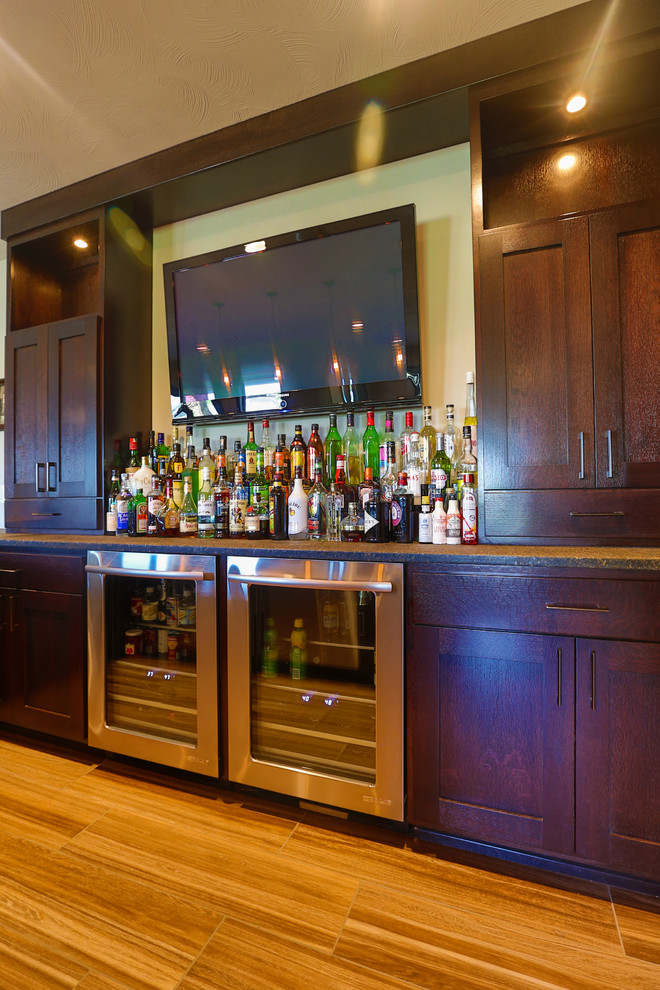 Foto di un grande bancone bar american style con ante in stile shaker, ante in legno bruno, top in quarzite e pavimento in gres porcellanato