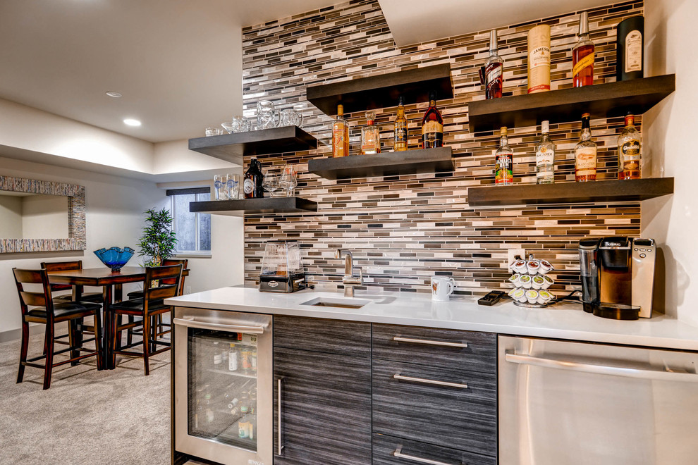 Photo of a large contemporary single-wall wet bar in Denver with a submerged sink, flat-panel cabinets, dark wood cabinets, engineered stone countertops, multi-coloured splashback, matchstick tiled splashback and ceramic flooring.