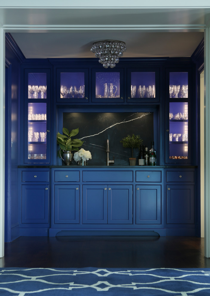 Inspiration for a small transitional single-wall dark wood floor wet bar remodel in New York with an undermount sink, blue cabinets, marble countertops, black backsplash, stone slab backsplash and shaker cabinets
