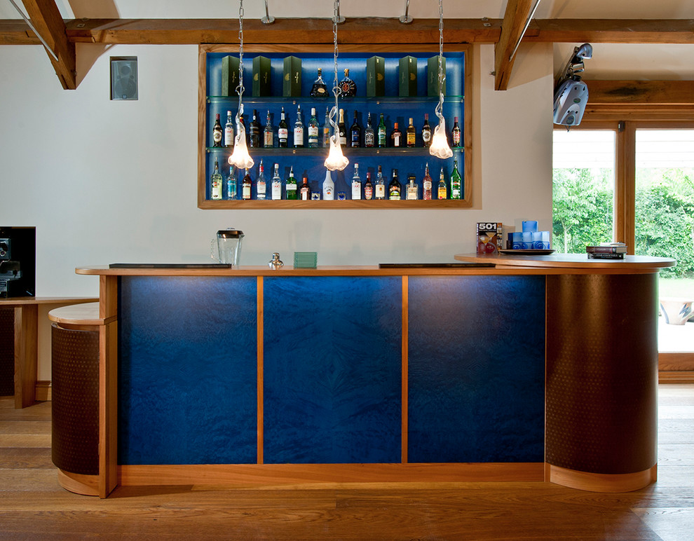 Design ideas for a medium sized contemporary galley home bar in Dorset with blue splashback.