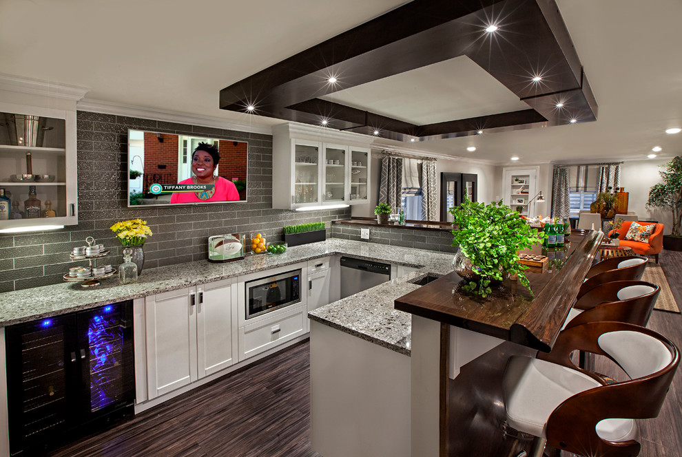Example of a large trendy l-shaped bamboo floor and brown floor kitchen design in Chicago with glass-front cabinets, white cabinets, wood countertops, gray backsplash, glass tile backsplash and an undermount sink