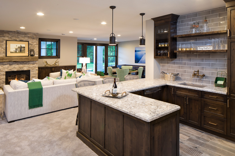 Photo of a large traditional home bar in Minneapolis with a submerged sink, engineered stone countertops and ceramic splashback.