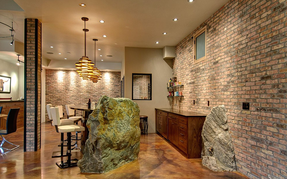 Inspiration for a large contemporary galley concrete floor and brown floor seated home bar remodel in Denver with flat-panel cabinets, dark wood cabinets, granite countertops, red backsplash and brick backsplash