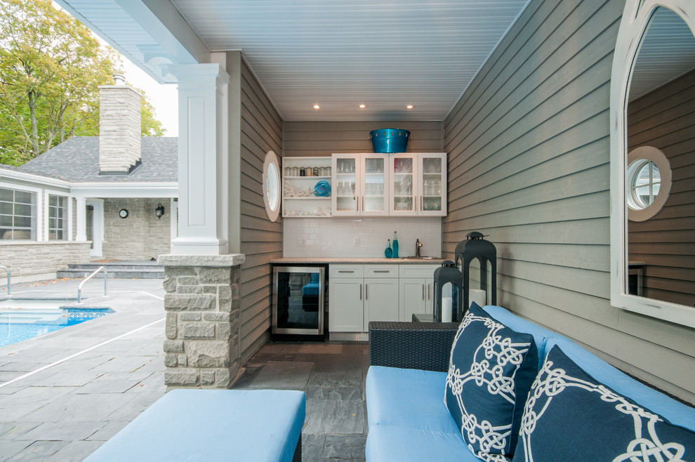 Example of a small beach style single-wall slate floor wet bar design in Toronto with a drop-in sink, shaker cabinets, white cabinets, granite countertops, white backsplash and subway tile backsplash