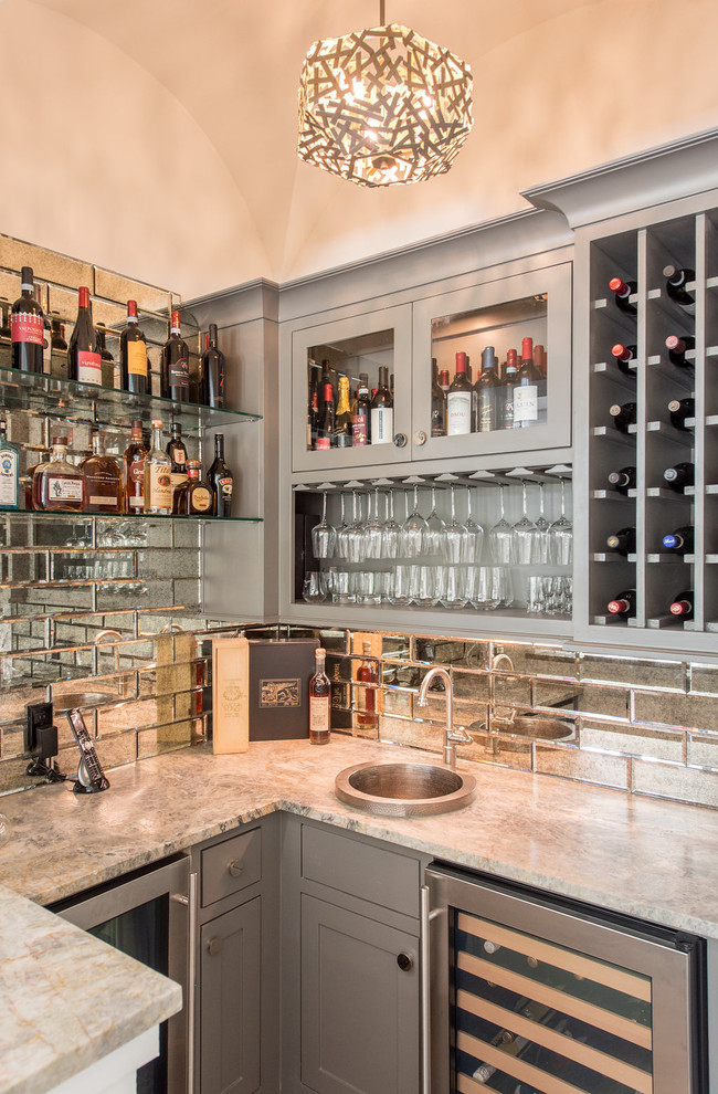Wet bar - mid-sized coastal u-shaped wet bar idea in Houston with a drop-in sink, gray cabinets, granite countertops, mirror backsplash, gray countertops and glass-front cabinets