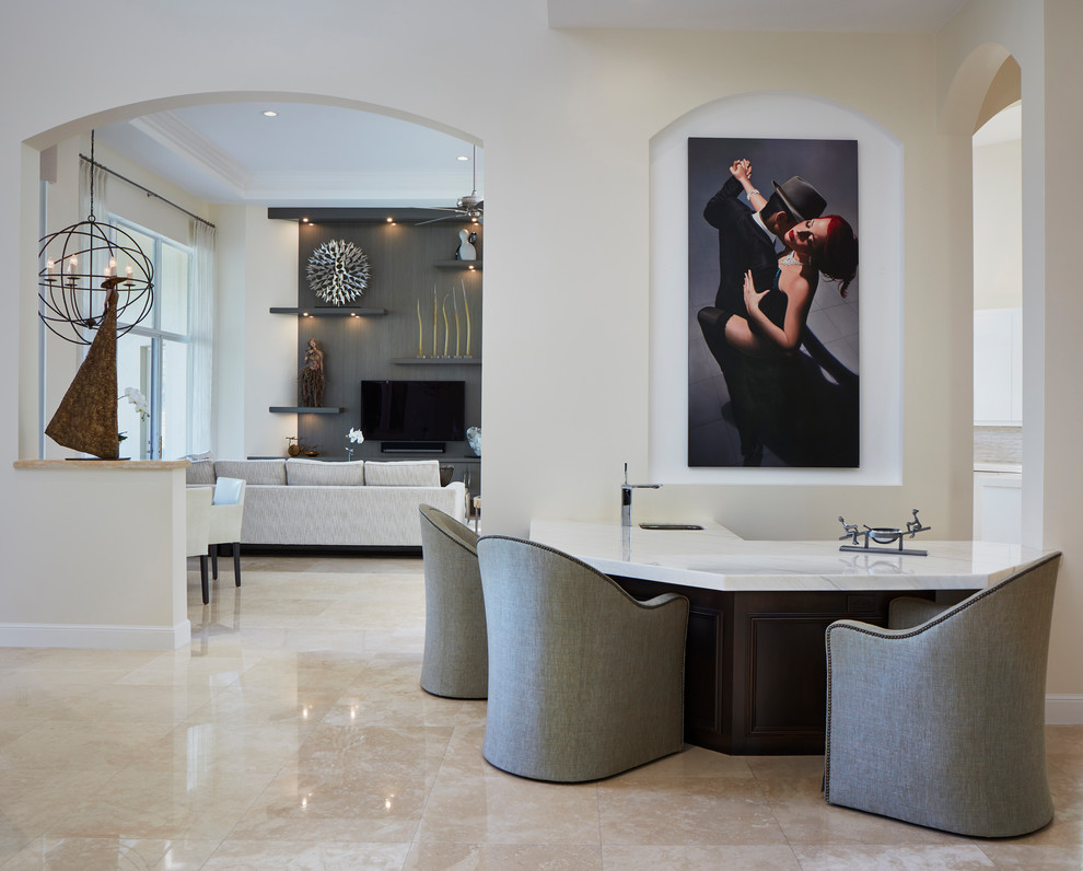 Seated home bar - mid-sized mediterranean l-shaped marble floor and beige floor seated home bar idea in Miami with an undermount sink and marble countertops