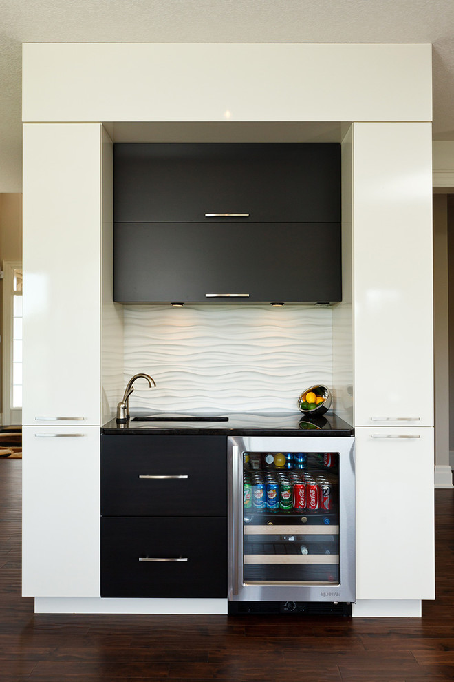 Photo of a contemporary wet bar in Toronto with flat-panel cabinets, black cabinets, white splashback and dark hardwood flooring.