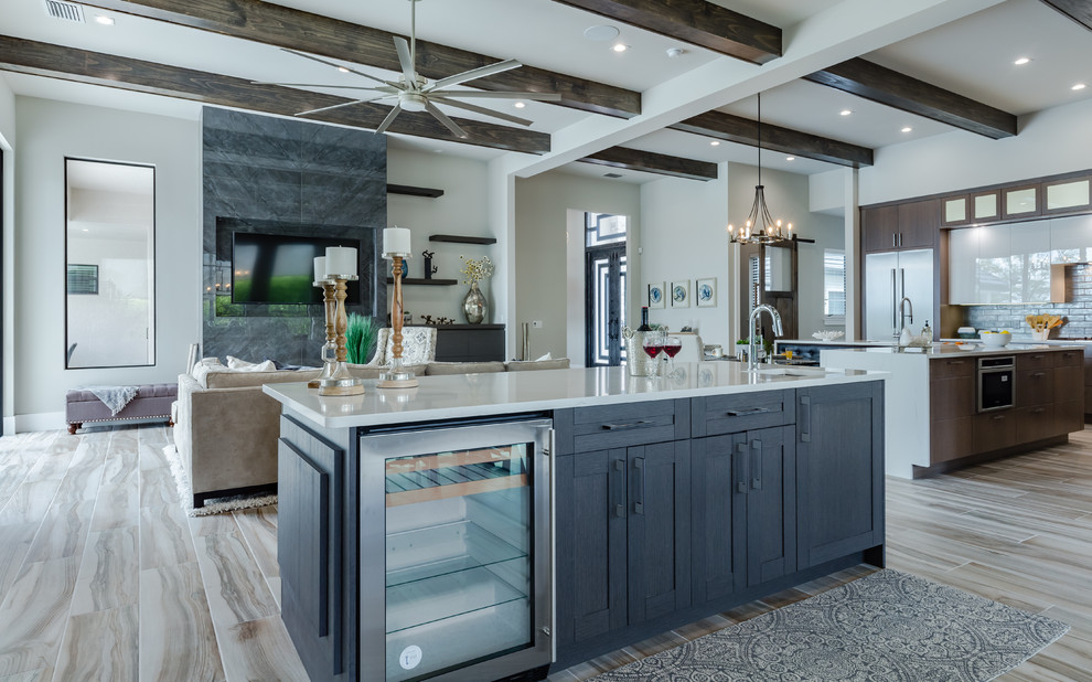 This is an example of a small contemporary galley wet bar in Tampa with a submerged sink, shaker cabinets, dark wood cabinets, engineered stone countertops, porcelain flooring, multi-coloured floors and white worktops.