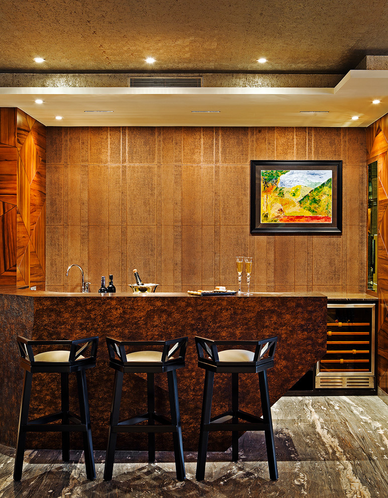 Example of a mid-sized trendy l-shaped marble floor seated home bar design in Bengaluru with brown cabinets and wood countertops
