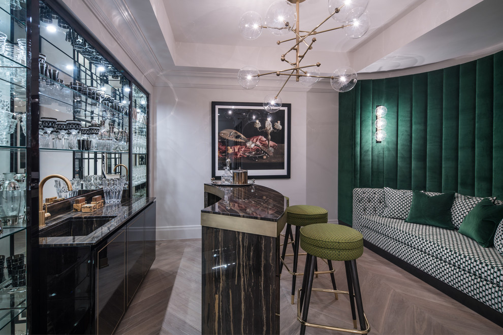 This is an example of a medium sized bohemian single-wall wet bar in London with a submerged sink, flat-panel cabinets, black cabinets, granite worktops, mirror splashback and beige floors.