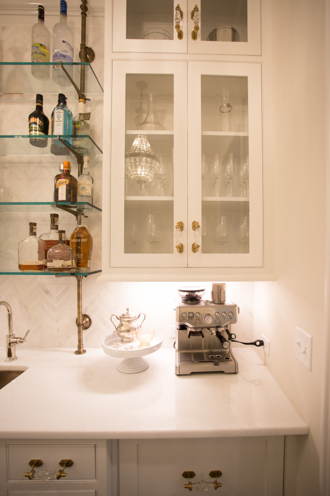 Immagine di un angolo bar con lavandino classico con ante a filo, ante bianche, pavimento in legno massello medio e top bianco