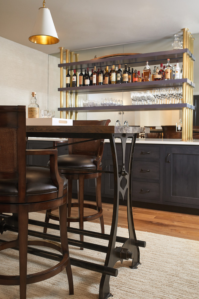 Photo of a traditional home bar in Grand Rapids with a submerged sink, flat-panel cabinets, black cabinets, quartz worktops, carpet and white worktops.