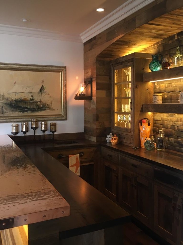 This is an example of a medium sized rustic u-shaped wet bar in Orange County with a built-in sink, shaker cabinets, medium wood cabinets, copper worktops, brown splashback, wood splashback, dark hardwood flooring and brown floors.