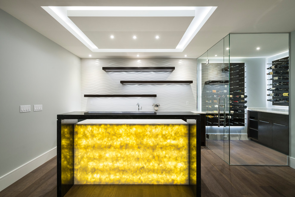 Photo of a medium sized contemporary galley home bar in Vancouver with flat-panel cabinets, dark wood cabinets, onyx worktops, white splashback, porcelain splashback, light hardwood flooring and brown floors.