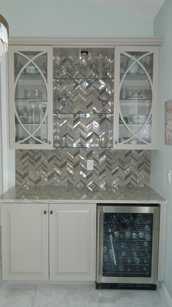 Example of a small transitional home bar design in Tampa with glass-front cabinets, gray cabinets and granite countertops