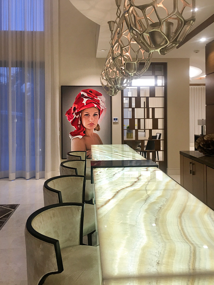 Huge transitional galley marble floor and beige floor seated home bar photo in Miami with an undermount sink, flat-panel cabinets, dark wood cabinets and onyx countertops