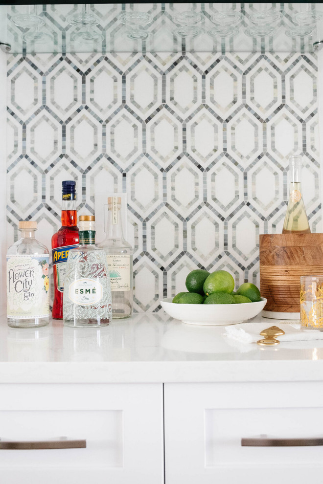 This is an example of a medium sized nautical single-wall home bar in Other with shaker cabinets, white cabinets, engineered stone countertops, blue splashback, stone tiled splashback and white worktops.