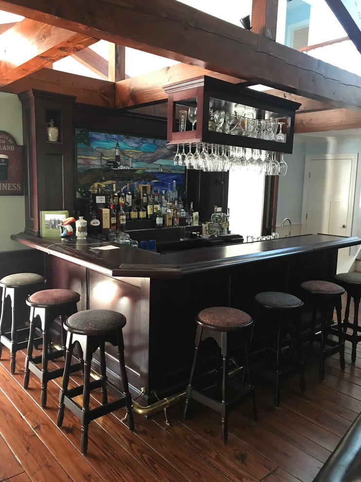 Inspiration for a rustic home bar in New York with medium hardwood flooring and brown floors.